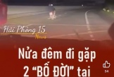 Hai người đàn ông đầu trần, đi xe máy lạng lách, đánh võng trên quốc lộ