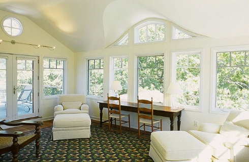 12cozy seating and a workdesk add to the appeal of the sunroom 1496975393418